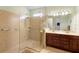 Large walk-in shower, double vanity, and tile flooring at 309 Chesham St, Ormond Beach, FL 32174