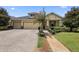 Two-story house with a three car garage, paver driveway, and landscaping at 309 Chesham St, Ormond Beach, FL 32174