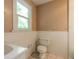 Clean bathroom with white tile and a toilet at 724 N Oleander Ave, Daytona Beach, FL 32118