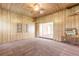 Spacious living room with wood paneling, carpeted floors, and AC unit at 724 N Oleander Ave, Daytona Beach, FL 32118