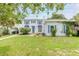 Two-story house with a white exterior, blue accents, and a green lawn at 724 N Oleander Ave, Daytona Beach, FL 32118