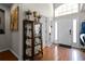 Bright entryway with hardwood floors and decorative cabinet at 1401 Bent Oaks Blvd, Deland, FL 32724