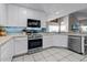 Modern kitchen with white cabinets and stainless steel appliances at 1401 Bent Oaks Blvd, Deland, FL 32724