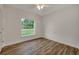 Bright bedroom with wood-look floors and a ceiling fan at 210 E Baxter St, De Leon Springs, FL 32130