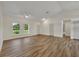 Bright living room with wood-look floors and ceiling fan at 210 E Baxter St, De Leon Springs, FL 32130