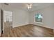 Well-lit bedroom featuring wood-look flooring and a ceiling fan at 210 E Baxter St, De Leon Springs, FL 32130