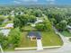 Aerial view of a house with a large green lawn at 210 E Baxter St, De Leon Springs, FL 32130