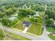 Aerial view showcasing a single-Gathering home in a residential area at 210 E Baxter St, De Leon Springs, FL 32130