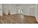 Bright living room with hardwood floors and closets at 210 E Baxter St, De Leon Springs, FL 32130