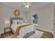 Bedroom with wood-look floors, ceiling fan, and window with backyard view at 210 E Baxter St, De Leon Springs, FL 32130