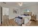 Bright bedroom with wood-look floors, ceiling fan and ample natural light at 210 E Baxter St, De Leon Springs, FL 32130