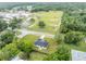 Aerial view showcasing a single-Gathering home situated on a quiet street near a school at 210 E Baxter St, De Leon Springs, FL 32130