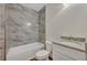 Bathroom with marble-look tile and granite vanity at 210 E Baxter St, De Leon Springs, FL 32130