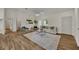 Bright living room featuring a comfy couch and large windows at 210 E Baxter St, De Leon Springs, FL 32130