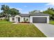 New construction home with a modern design and dark garage door at 210 E Baxter St, De Leon Springs, FL 32130
