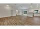 Open living room with kitchen and vaulted ceiling at 210 E Baxter St, De Leon Springs, FL 32130