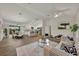 Open concept living room and kitchen with wood-look tile floors at 210 E Baxter St, De Leon Springs, FL 32130