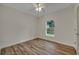Bedroom with wood-look flooring, a ceiling fan, and large window at 210 E Baxter St, De Leon Springs, FL 32130