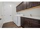 Convenient laundry room with washer, dryer, and cabinets at 6287 Woodhaven Village Dr, Port Orange, FL 32128