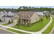 Tan two-story house with brown roof, stone accents, and a two-car garage at 6287 Woodhaven Village Dr, Port Orange, FL 32128