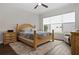 Bright bedroom with wood flooring, a comfortable bed, and ample natural light at 6287 Woodhaven Village Dr, Port Orange, FL 32128