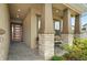 Inviting front porch with stone columns and a modern front door at 6287 Woodhaven Village Dr, Port Orange, FL 32128