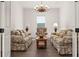 Cozy living room with two sofas, a coffee table, and a chandelier at 6287 Woodhaven Village Dr, Port Orange, FL 32128