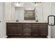 Double vanity bathroom with dark brown cabinets and a large mirror at 6287 Woodhaven Village Dr, Port Orange, FL 32128