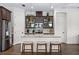 Modern kitchen with dark cabinets, quartz countertops, and island seating at 6287 Woodhaven Village Dr, Port Orange, FL 32128