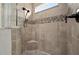 Spa-like shower with herringbone tile and a built-in seat at 6287 Woodhaven Village Dr, Port Orange, FL 32128