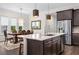 Open kitchen with large island, stainless steel appliances, and breakfast bar at 6287 Woodhaven Village Dr, Port Orange, FL 32128