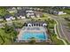 Aerial view of community pool, playground, and residential homes at 6287 Woodhaven Village Dr, Port Orange, FL 32128