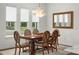 Elegant dining room with large chandelier and hardwood floors at 6287 Woodhaven Village Dr, Port Orange, FL 32128