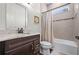 Bathroom with a bathtub, shower, and dark brown vanity at 6287 Woodhaven Village Dr, Port Orange, FL 32128