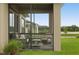 Relaxing screened porch with patio furniture and backyard view at 6287 Woodhaven Village Dr, Port Orange, FL 32128