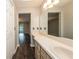 Bright bathroom with a vanity, sink, and large mirror at 34 Fairway Dr # 1, Debary, FL 32713