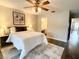 Main bedroom with wood-look floors, ceiling fan and en-suite bathroom at 34 Fairway Dr # 1, Debary, FL 32713