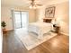Main bedroom with wood-look floors, ceiling fan, and sliding doors at 34 Fairway Dr # 1, Debary, FL 32713