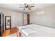 Bright bedroom with hardwood floors, ceiling fan, and mirrored closet doors at 505 Wisteria Rd, Daytona Beach, FL 32118