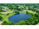 Aerial shot of a community with a central lake surrounded by lush vegetation at 34 Fairway Dr # 1, Debary, FL 32713
