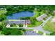 Aerial view showcasing a villa near a lake in a residential community at 34 Fairway Dr # 1, Debary, FL 32713