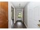 Bright hallway with wood-look floors leading to rooms at 34 Fairway Dr # 1, Debary, FL 32713