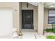 Inviting front entrance with a black metal security door at 34 Fairway Dr # 1, Debary, FL 32713