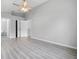 Spacious main bedroom with vinyl plank flooring, ceiling fan, and access to en-suite bathroom at 1790 17Th St, Orange City, FL 32763