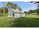 Side view of house showcasing backyard and landscaping at 1790 17Th St, Orange City, FL 32763