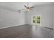 Spacious living room with wood-look floors and French doors at 1790 17Th St, Orange City, FL 32763