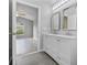 Updated bathroom with double vanity, view of bedroom, and modern fixtures at 1790 17Th St, Orange City, FL 32763