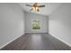 Spacious bedroom with dark laminate flooring and large window at 1790 17Th St, Orange City, FL 32763
