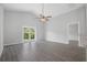 Spacious living room with wood-look floors and French doors at 1790 17Th St, Orange City, FL 32763
