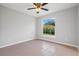 Spacious bedroom with tile flooring, ceiling fan and window with backyard view at 1790 17Th St, Orange City, FL 32763